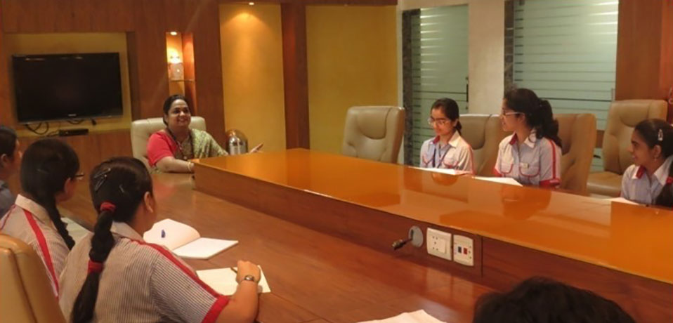 school with seminar hall,the image shows students sitting in conference hall
