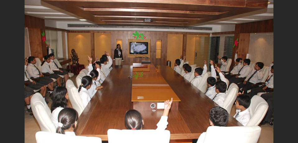 the image shows students of secondary wing taking part in conference,school with conference hall
