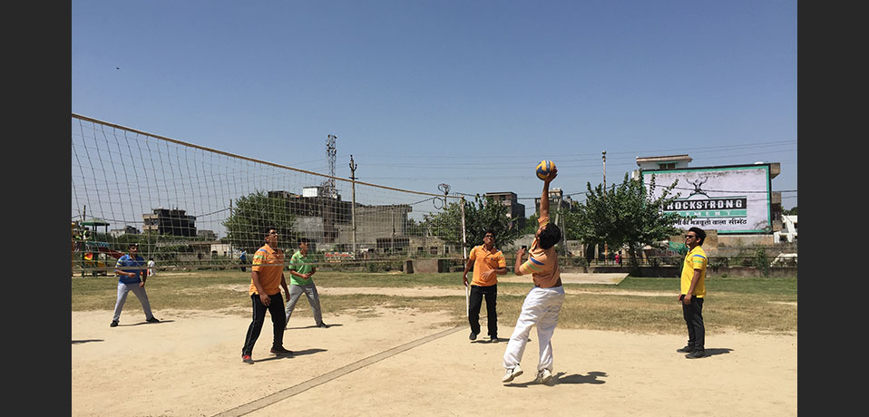 best school for sports in delhi,the image shows student playing volleyball 
