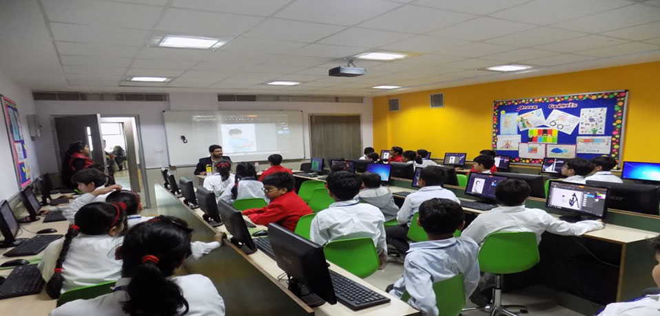 the image shows the students are studying in computer lab,school with smart class
