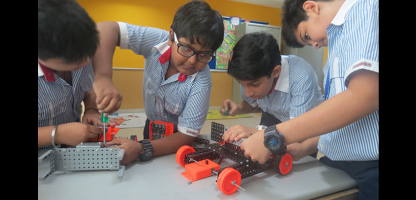 the image shows the students of secondary wing doing their science project,best seconadry school
