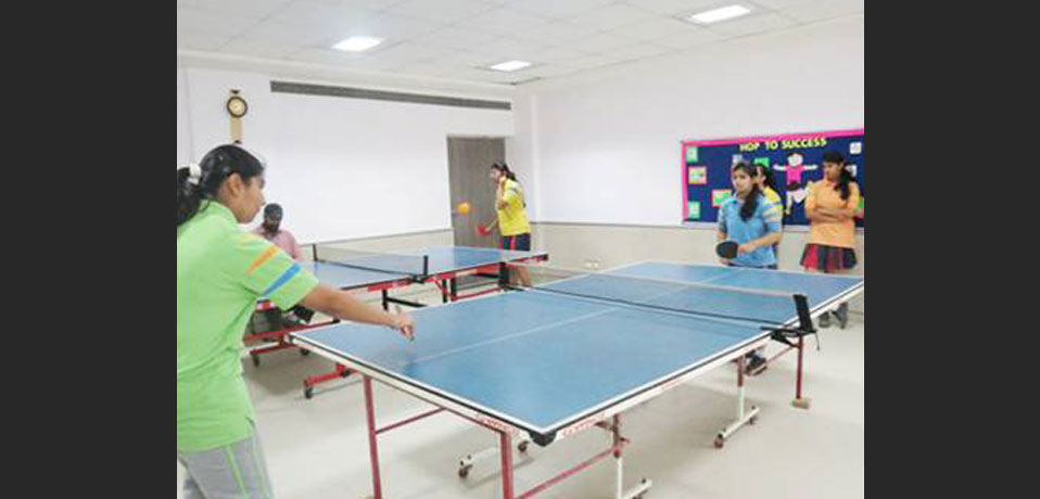 the image shows team of girl studnets playing table tennies, school best in indoor games
