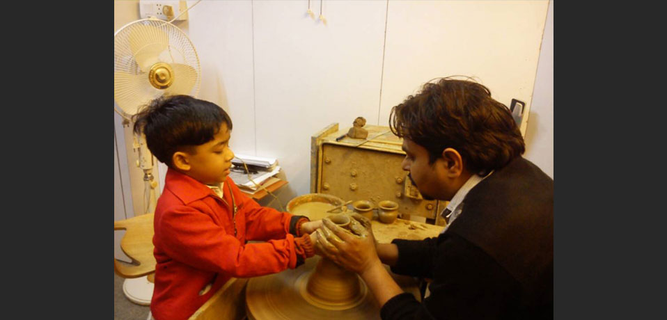 school best in extra curricular activities,teacher and student enjoying pottery class
