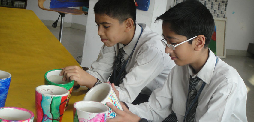 school best in extra curricular activities,teacher and student enjoying pottery class
