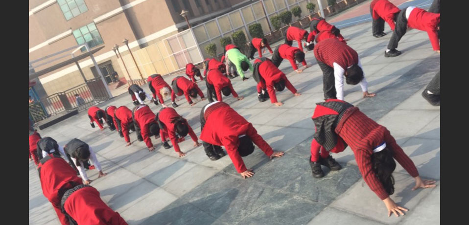 the image shows the students of gd goenka doing yoga in school campus,yoga in school
